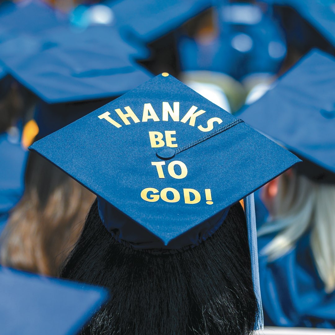 Cap reads “Thanks Be to God” in gold letters