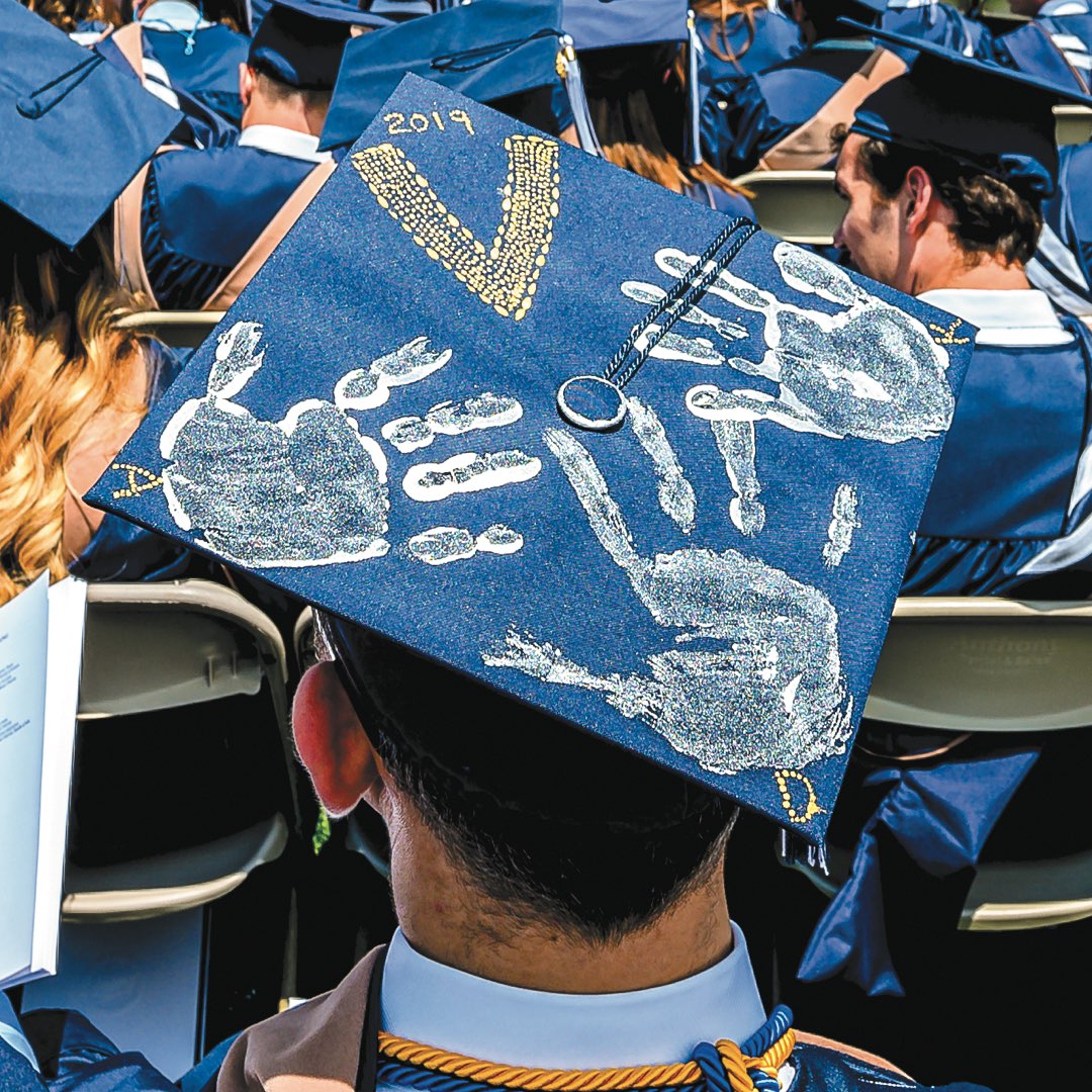 Cap with painted handprints on it.