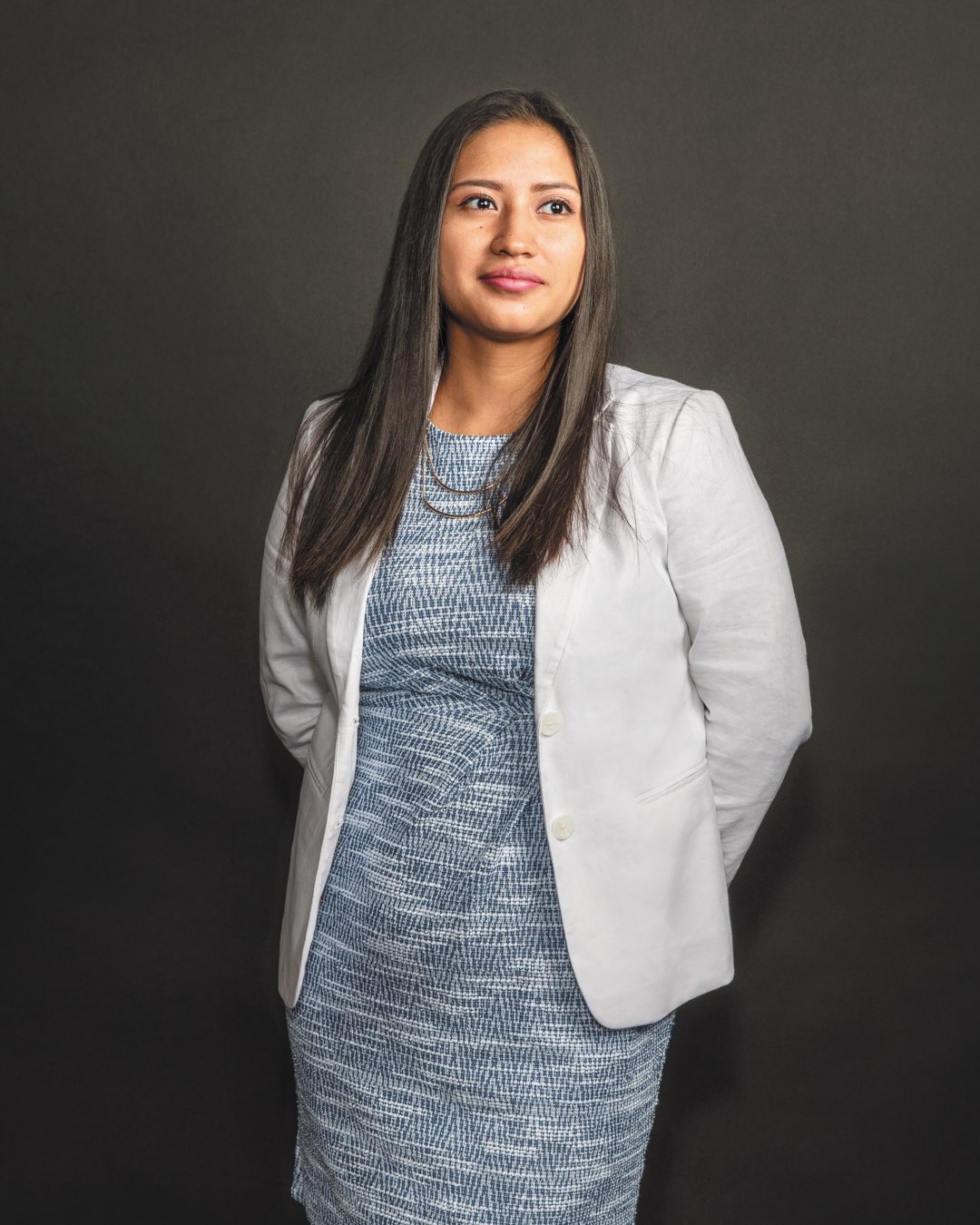 Rising senior Erika Llivicota-Guaman standing in a blue career dress with white blazer