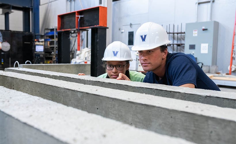 Department of Civil and Environmental Engineering A professor and student wearing Villanova hardhats in the structures lab