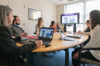 Classical studies professor with graduate students in hybrid in-person online class