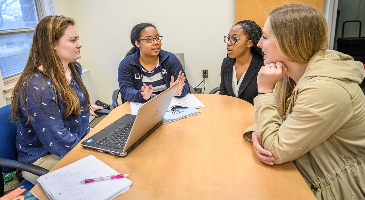 Graduate students in discussion around a conference table Graduate students in discussion around a conference table