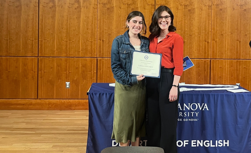 English student holding up award image of student holding up award