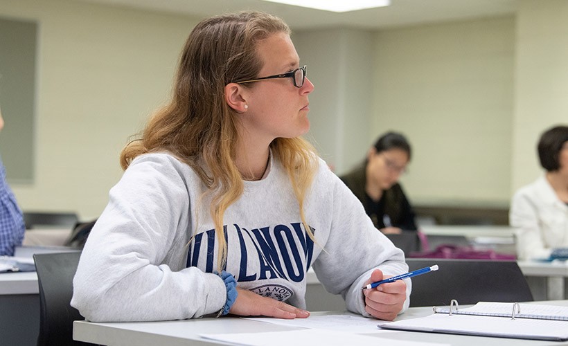 A female student listens to a lecture in a mathematics class. A female student listens to a lecture in a mathematics class.