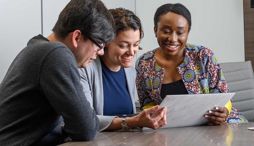 Theatre students in the nonprofit management track working on a group project sitting at a table Theatre students in the nonprofit management track working on a group project sitting at a table