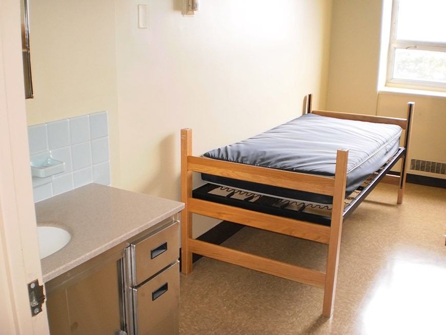 St. Mary's Hall single room View of a bed and sink and vanity in a St. Mary's Hall single room.