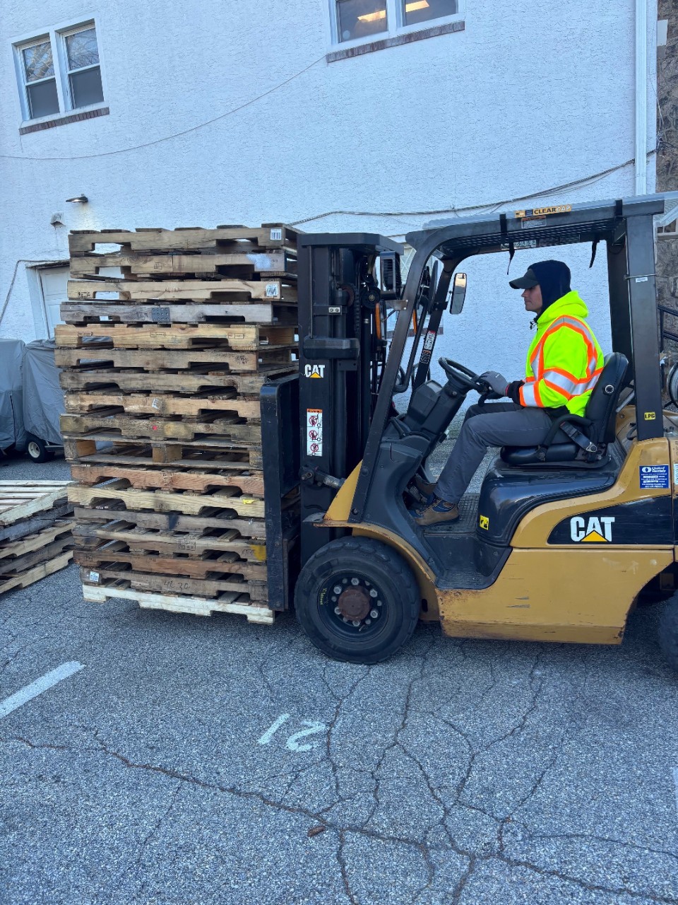 Dan Haley loading recovered pallets for resale