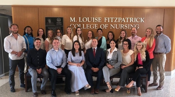 1st class of 21 DNP-NA students after Scholarly project presentations in July-graduated Dec 2021 - CROPPED 21 students posing for photo in Driscoll Hall lobby