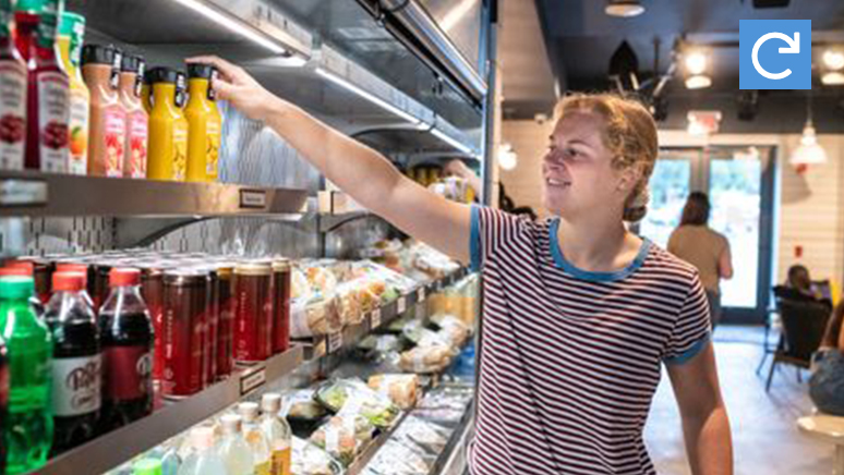 Female student is selecting her food at the cafeteria