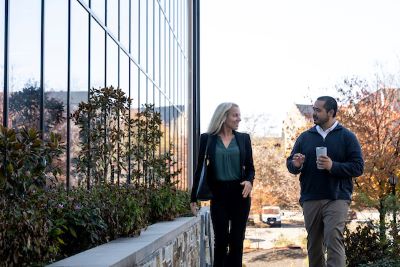 two people walking and talking outside