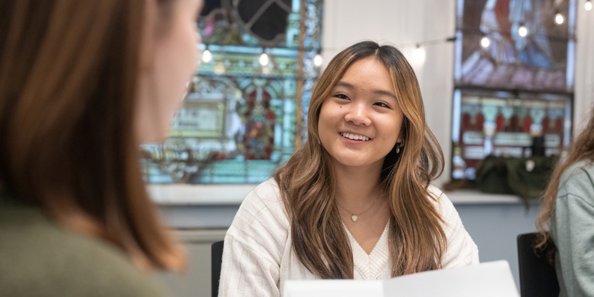 Students conversing in a classroom.